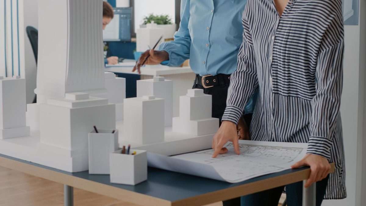 close up of a focus energy team looking at the blue prints and floor plans t o calculate sap energy effeciency scaled 2